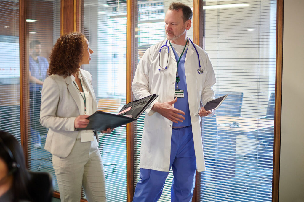 healthcare administrator showing doctor documents in folder