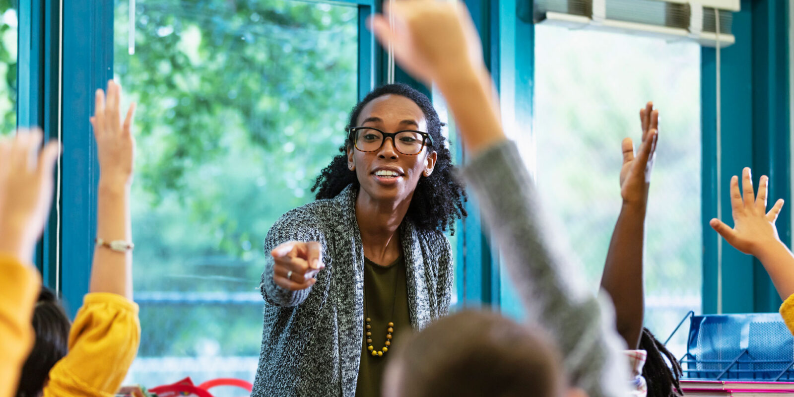 teacher pointing at student with and raised