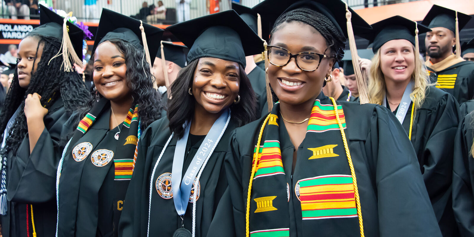 Group of AUM graduates in cap and gowns